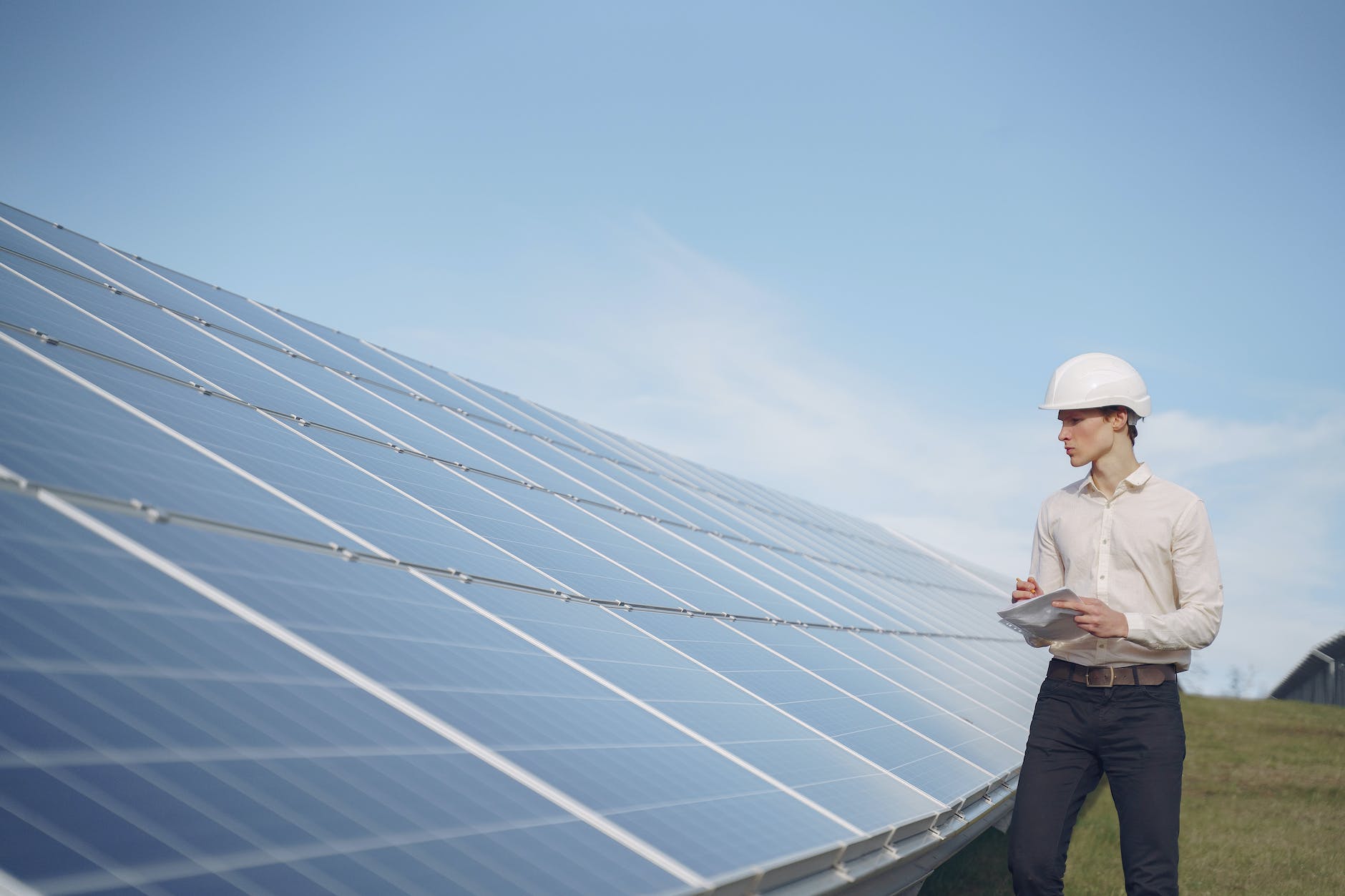 solar technician inspecting solar panel