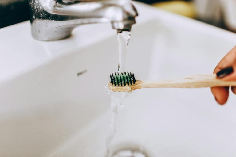 toothbrush under water in sink